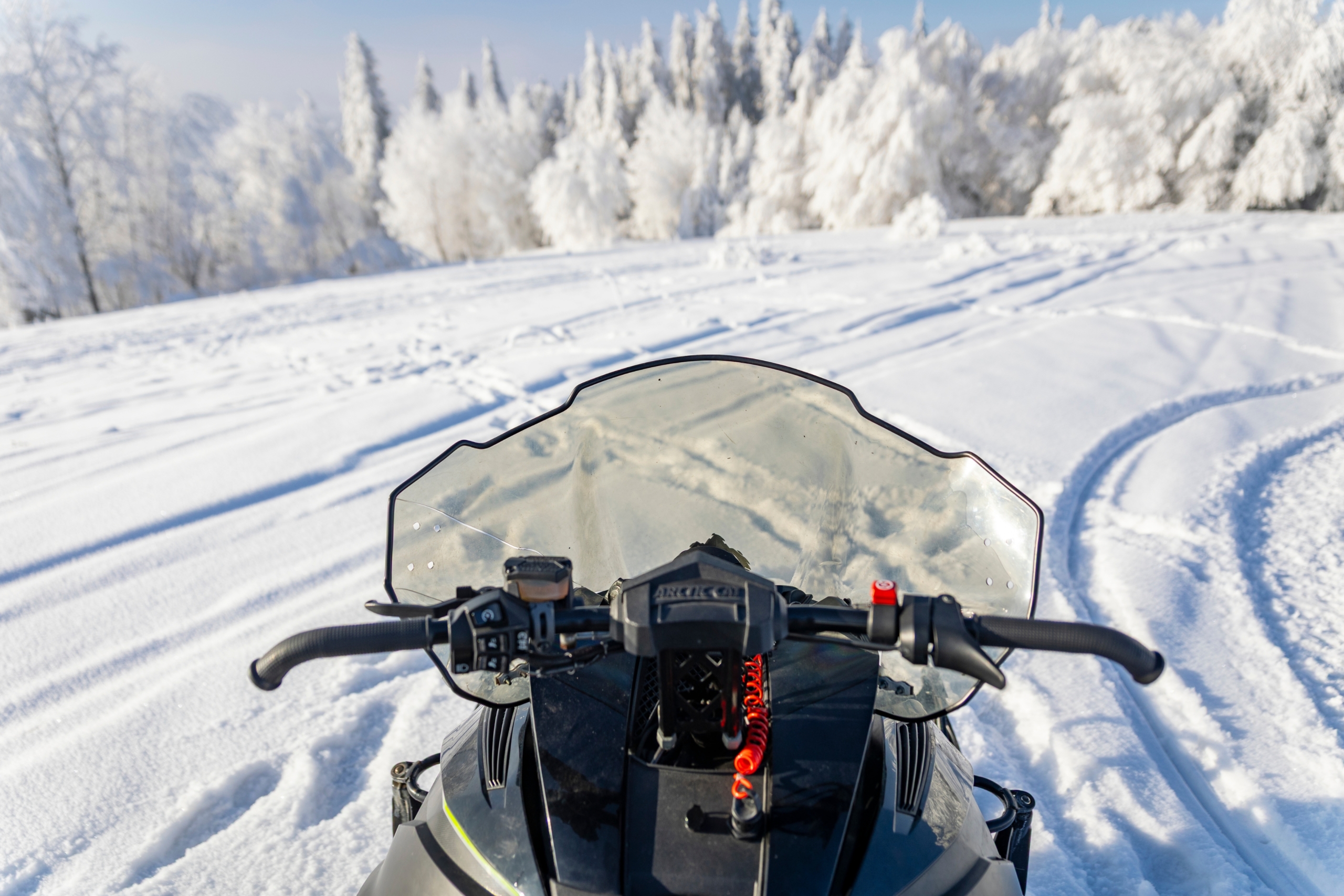 snowmobile-handlebar-view-zakopane Rider view from a snowmobile on fresh snow near Zakopane