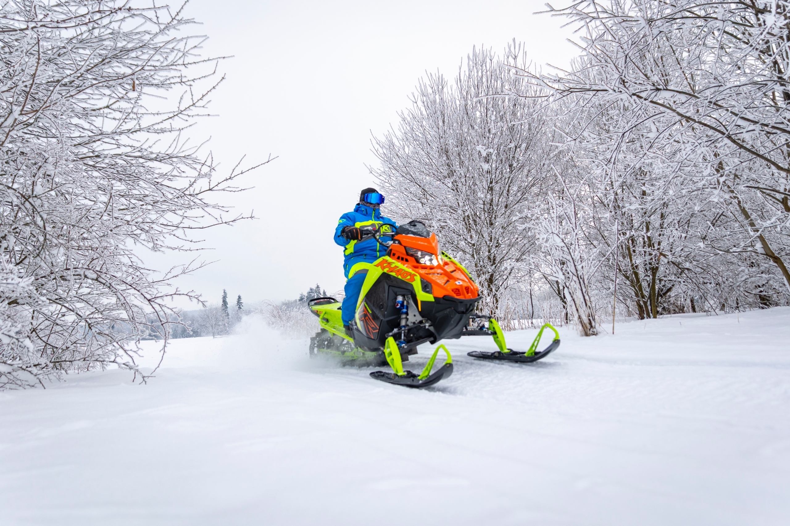 snowmobile-rider-action-zakopane Snowmobile rider speeding through fresh snow near Zakopane