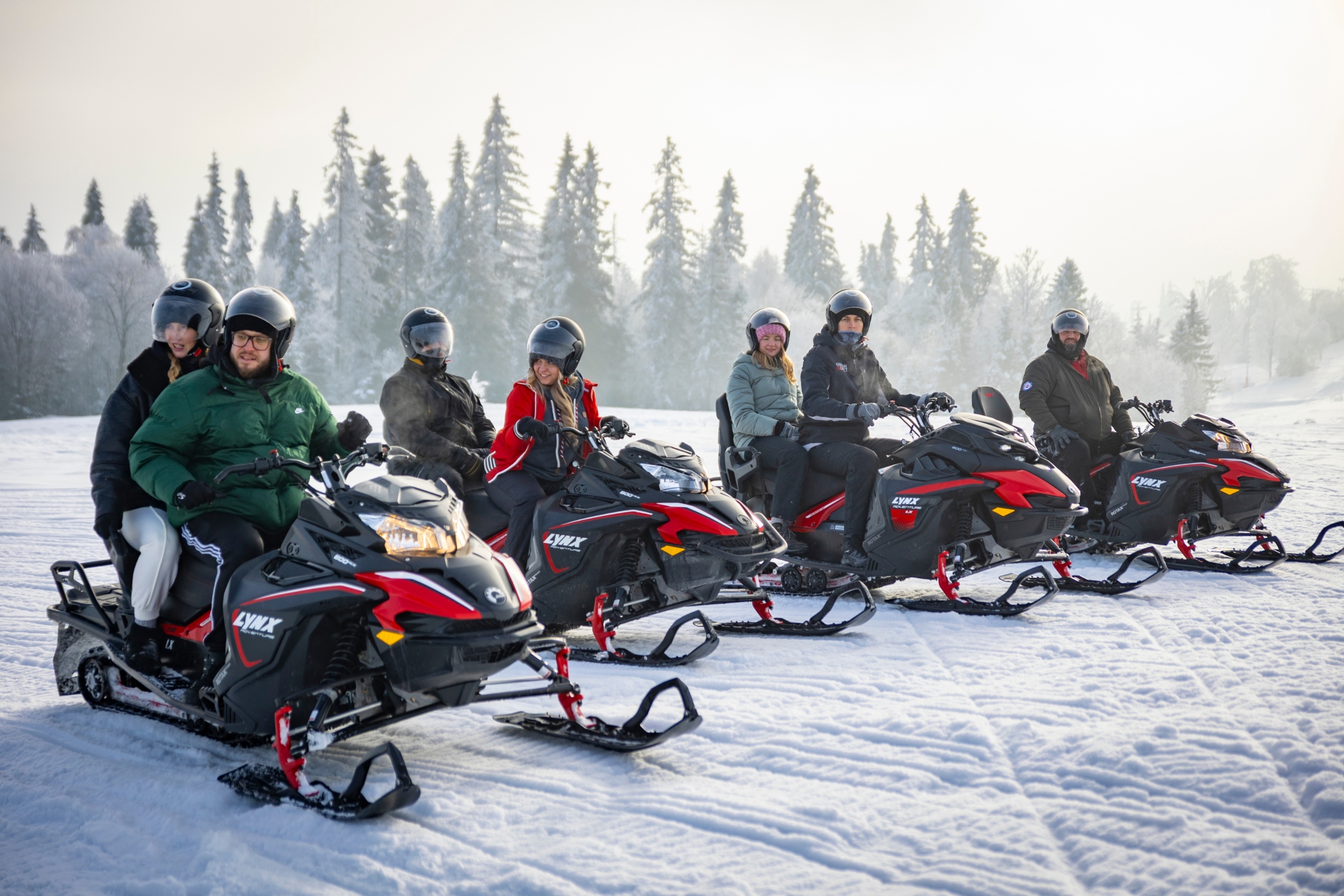 snowmobile-tour-group-lineup Snowmobile tour group lined up on a snowy trail in the Tatra region