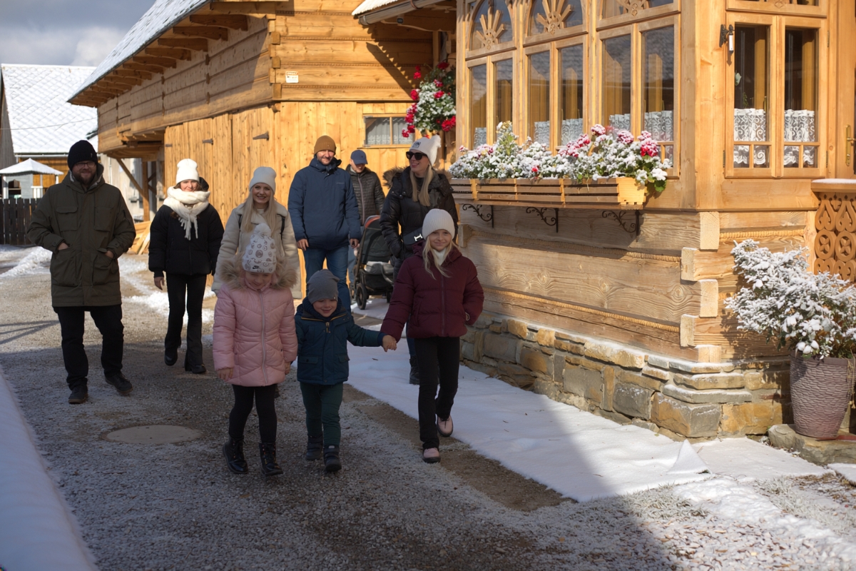 zakopane-winter-family-walk Families walking past wooden buildings in Zakopane during winter